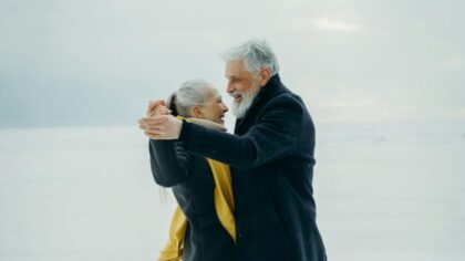 Older couple dancing outside