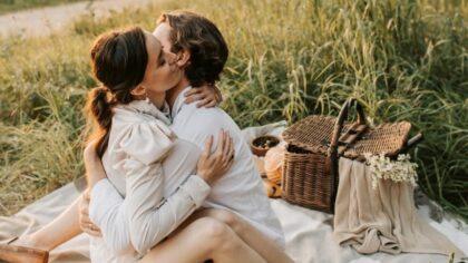 Husband and wife hugging and having picnic