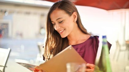 A Smiling Woman While Reading